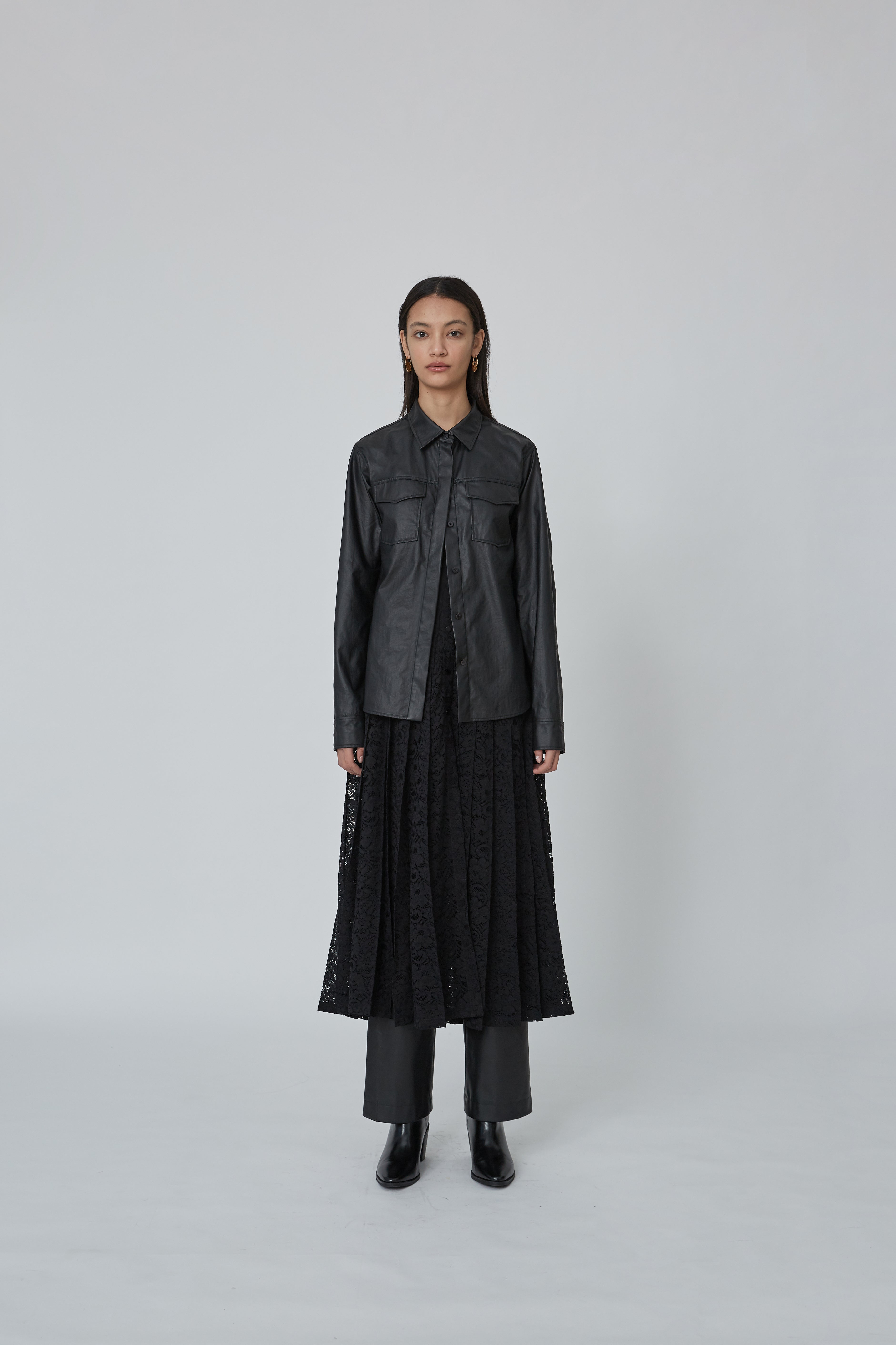 Coated shirt layered with a pleated corded lace dress Coated shirt layered with a pleated corded lace dress